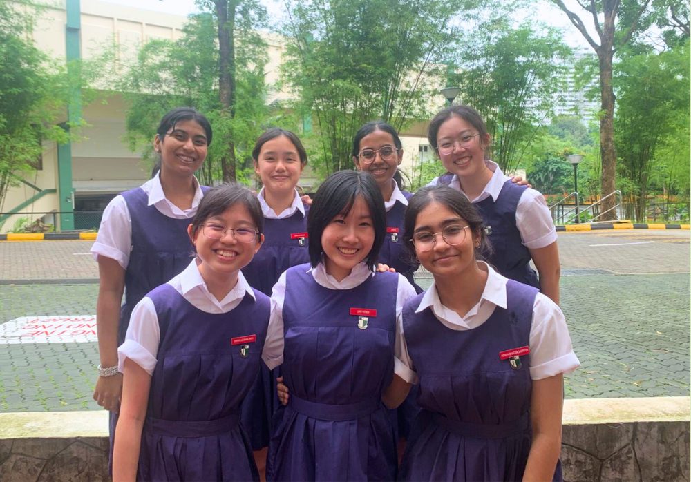 Seven Raffles Institution students in school uniform, the team behind Project STEMulate