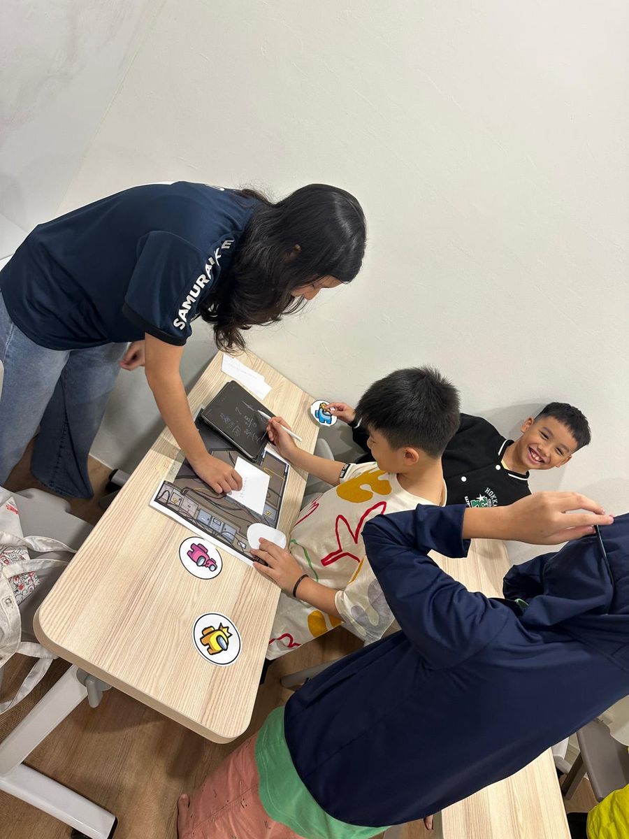 Volunteers helping children with an activity at a low table